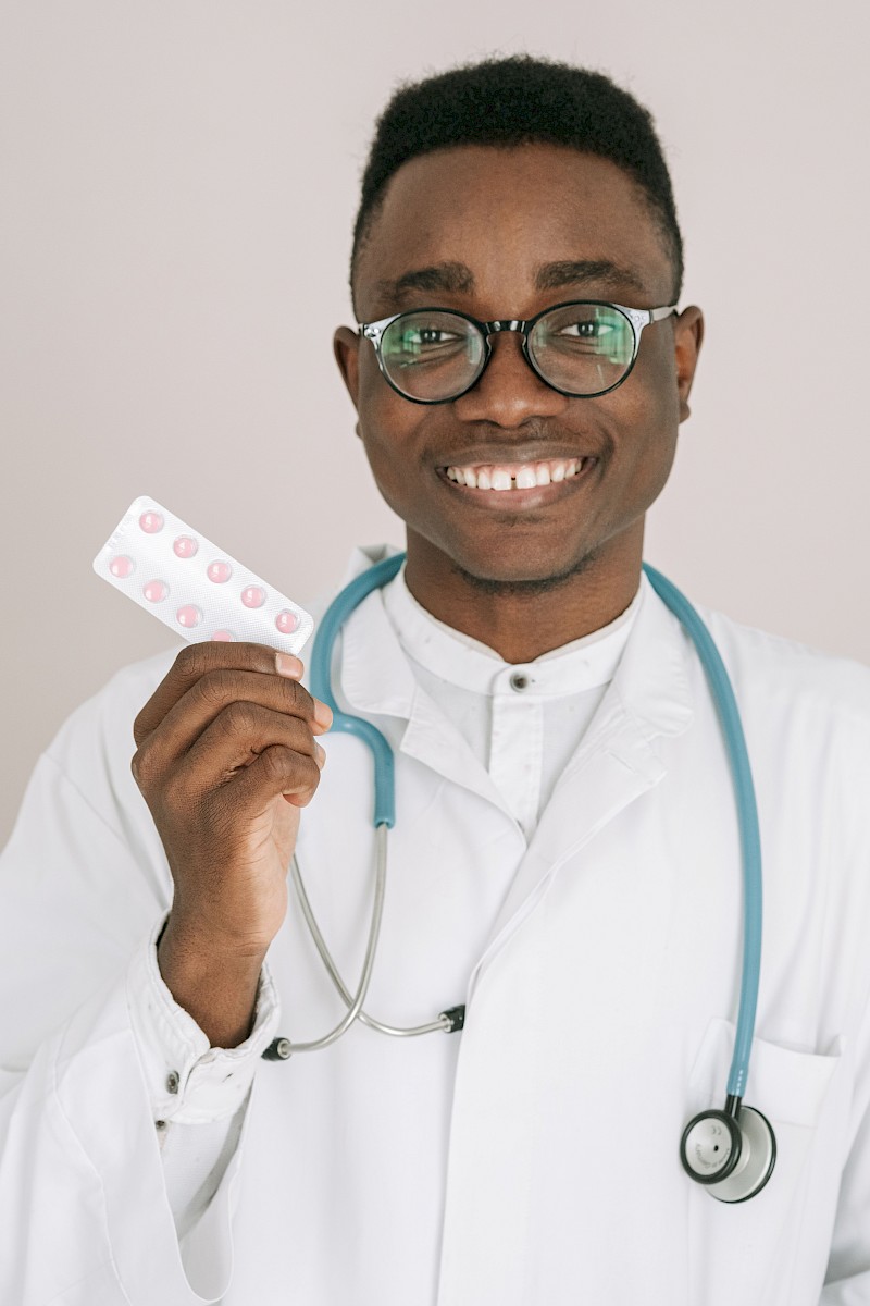 Doctor looking in to patient's eye with light in clinic