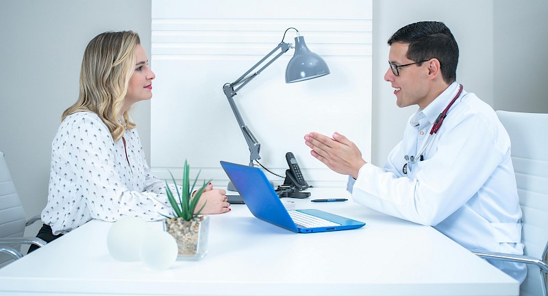 meting between male doctor and saleswoman in hospital meeting room